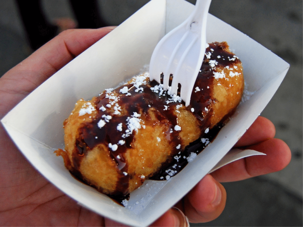 deep fried mars bar  A deep fried mars bar, covered in chocolate sauce with a fork
