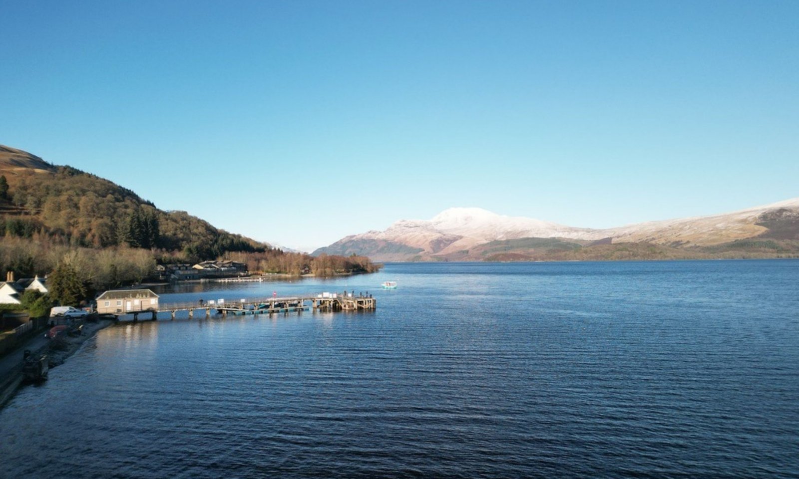 Luss pier on Loch Lomond with snow capped Ben Lomond in the distance, the loch within easy reach of Glasgow for anyone heading north into the Highlands.